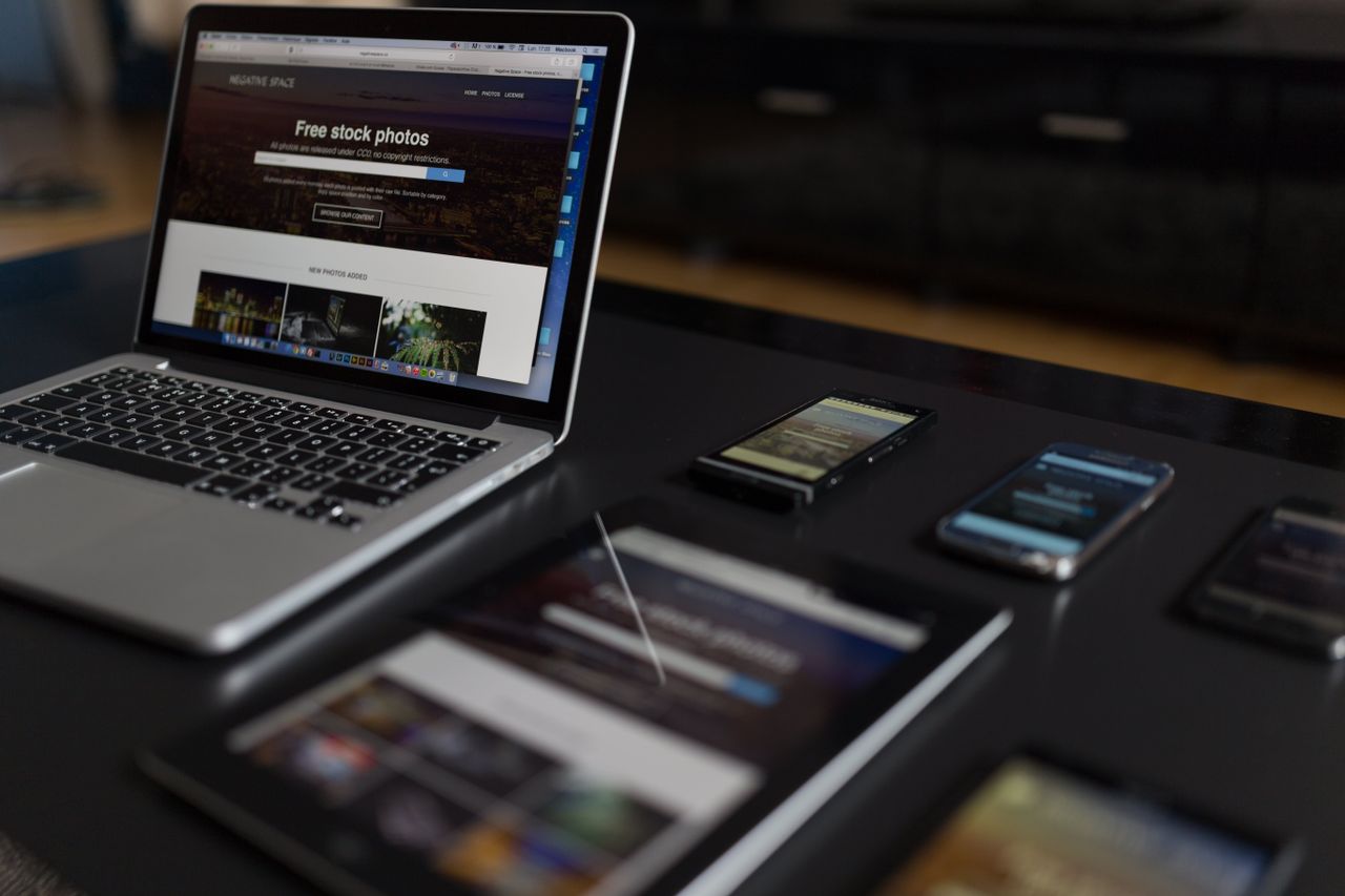 our-experience A contemporary workspace showcasing a laptop, tablet, and smartphones, ideal for tech and freelance use.